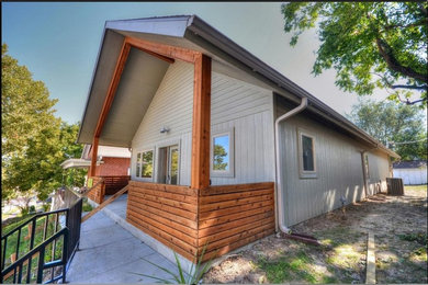 Small trendy beige one-story mixed siding gable roof photo in Kansas City