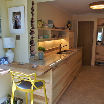 Galley kitchen in Ash with carvings