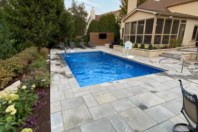 Inspiration for a large transitional backyard stone and rectangular lap and privacy pool remodel in Chicago