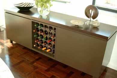 Small contemporary wine cellar in Sydney with dark hardwood floors and storage racks.