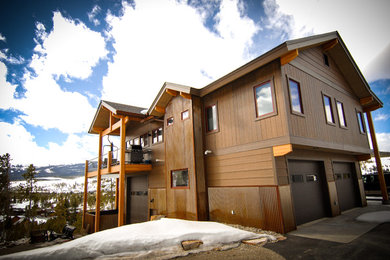 Large trendy brown split-level metal exterior home photo in Denver with a shingle roof