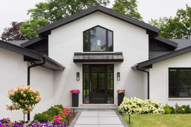 Huge contemporary white one-story brick exterior home idea in Chicago