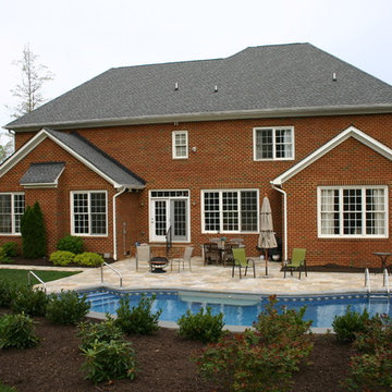 Natural Pool with Travertine Deck & Stone Retaining Wall