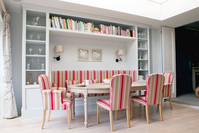 Photo of a scandinavian dining room in London with light hardwood floors.