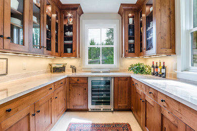 Transitional u-shaped kitchen pantry with an undermount sink, shaker cabinets, medium wood cabinets, marble benchtops, stainless steel appliances, no island and white benchtop.