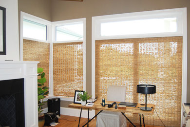 Inspiration for a mid-sized contemporary freestanding desk light wood floor study room remodel in Miami with beige walls and a standard fireplace