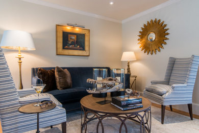 Example of a mid-sized transitional open concept medium tone wood floor and brown floor family room design in Boston with gray walls and no fireplace
