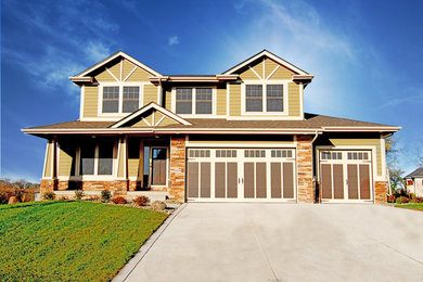 Large arts and crafts green three-story concrete fiberboard gable roof photo in Other