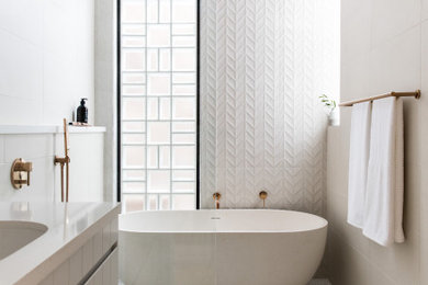 Mid-sized contemporary master wet room bathroom in Sydney with flat-panel cabinets, grey cabinets, a freestanding tub, white tile, porcelain tile, porcelain floors, an undermount sink, white floor, an open shower, beige benchtops, a single vanity and a floating vanity.