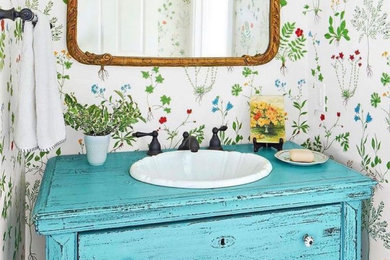 Design ideas for an eclectic powder room with blue cabinets and a freestanding vanity.