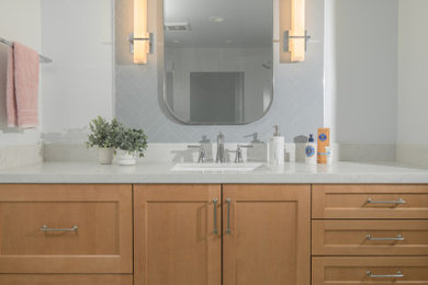 Mid-sized trendy master white tile and porcelain tile porcelain tile, white floor and single-sink shower bench photo in San Francisco with shaker cabinets, light wood cabinets, a bidet, white walls, an undermount sink, quartz countertops, a hinged shower door, white countertops and a built-in vanity