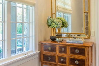Inspiration for a mid-sized timeless medium tone wood floor hallway remodel in DC Metro with beige walls