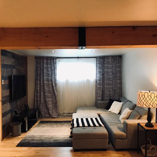 Small farmhouse look-out basement in Montreal with white walls, laminate floors, no fireplace and beige floors.