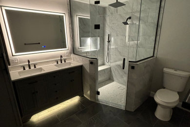 Large minimalist master gray tile and ceramic tile ceramic tile, black floor and double-sink bathroom photo in New York with shaker cabinets, gray cabinets, a two-piece toilet, gray walls, an undermount sink, quartz countertops, a hinged shower door, white countertops and a freestanding vanity
