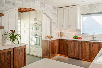 Example of a small minimalist porcelain tile, gray floor and wood ceiling eat-in kitchen design in Indianapolis with a single-bowl sink, shaker cabinets, medium tone wood cabinets, quartz countertops, white appliances and a peninsula