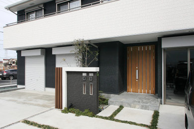 東京23区にあるおしゃれな家の外観 (コンクリート繊維板サイディング) の写真