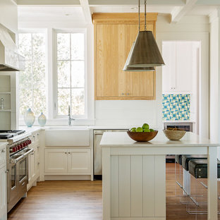 Beach style kitchen pantry photos - Kitchen pantry - beach style l-shaped medium tone wood floor kitchen pantry idea in Charleston with a farmhouse sink, shaker cabinets, light wood cabinets, blue backsplash, mosaic tile backsplash, stainless steel appliances and an island