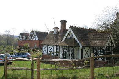 Medium sized and multi-coloured victorian bungalow brick detached house in Kent with a pitched roof and a tiled roof.