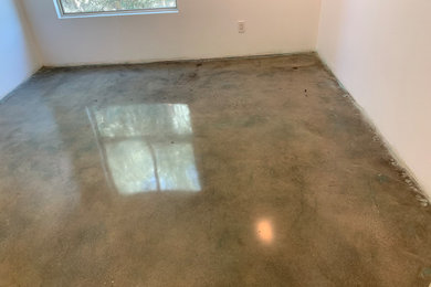 Example of a small concrete floor and gray floor bedroom design in Los Angeles