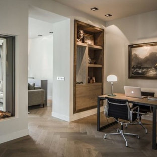 Large modern home office and library in Boston with no fireplace and a plastered fireplace surround.