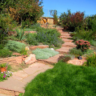 Design ideas for a large country backyard full sun garden for winter in Denver with a garden path and natural stone pavers.