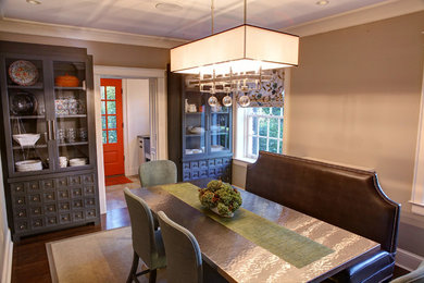 Example of a minimalist dark wood floor dining room design in Baltimore with beige walls