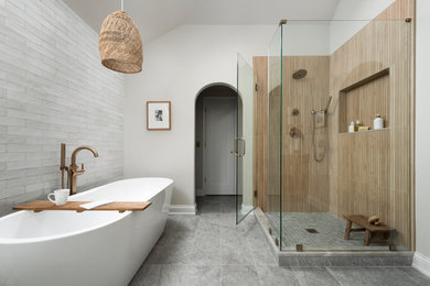 Example of a large trendy master beige tile and porcelain tile porcelain tile, beige floor, double-sink and vaulted ceiling bathroom design in Chicago with shaker cabinets, light wood cabinets, a one-piece toilet, beige walls, an undermount sink, quartzite countertops, a hinged shower door, beige countertops and a built-in vanity