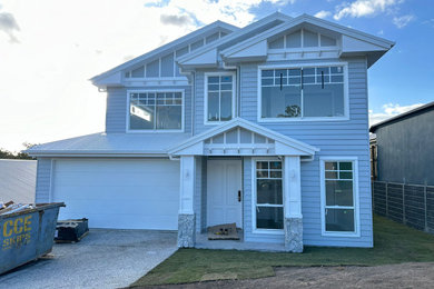 Inspiration for a grey house exterior in Brisbane with a gable roof, a metal roof and a white roof.