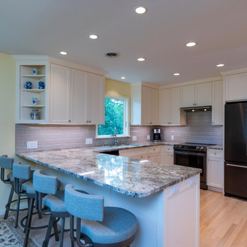 Modern Kitchen With White Painted Shaker Style Cabinets With a Bevel