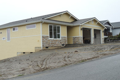 Example of a large transitional yellow two-story concrete fiberboard exterior home design in Seattle