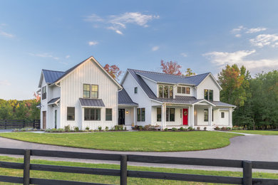 Example of a large country white two-story concrete fiberboard exterior home design in DC Metro with a metal roof