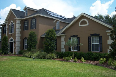 Large beige one-story stucco exterior home photo in Tampa