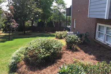 This is an example of a small full sun side yard landscaping in Birmingham.