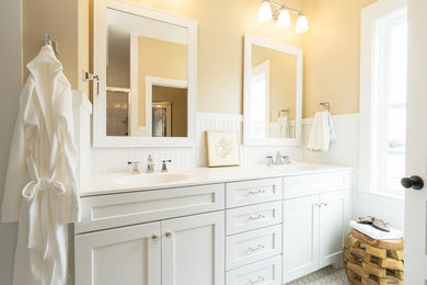 Inspiration for a beach style bathroom in Philadelphia with a wall-mount sink, shaker cabinets and white cabinets.
