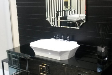 Example of a large classic master bathroom design in London with a vessel sink, furniture-like cabinets, black cabinets, glass countertops and black walls