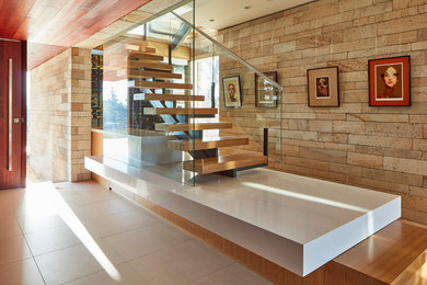 This is an example of a mid-sized contemporary wood u-shaped staircase in San Francisco with wood risers.