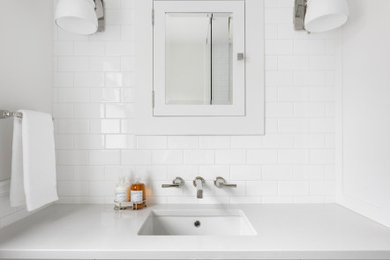 Small elegant 3/4 white tile and subway tile linoleum floor, green floor, single-sink and wainscoting bathroom photo in Portland with shaker cabinets, white cabinets, a one-piece toilet, white walls, an undermount sink, quartz countertops, white countertops, a niche and a built-in vanity