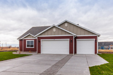 Example of a mid-sized classic red two-story concrete fiberboard exterior home design in Other with a shingle roof