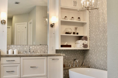 Photo of a large transitional master bathroom in Houston with recessed-panel cabinets, white cabinets, a freestanding tub, a curbless shower, a one-piece toilet, white tile, porcelain tile, grey walls, porcelain floors, an undermount sink, quartzite benchtops, grey floor, a hinged shower door, grey benchtops, an enclosed toilet, a double vanity and a built-in vanity.