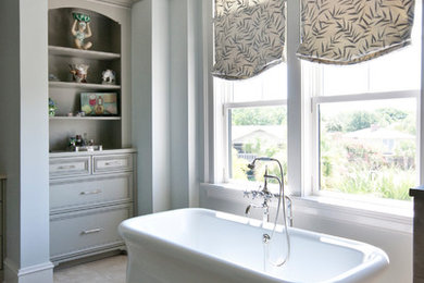 Freestanding bathtub - large traditional master ceramic tile and beige floor freestanding bathtub idea in Charleston with recessed-panel cabinets, beige cabinets, beige walls and an undermount sink