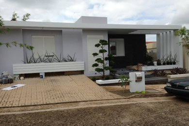 Inspiration for a mid-sized modern gray one-story concrete exterior home remodel in Other