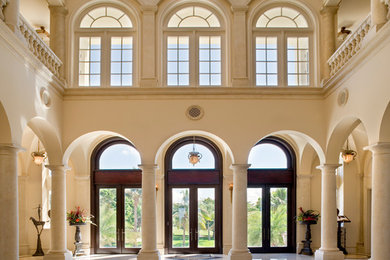 Example of a huge classic marble floor and multicolored floor foyer design in Tampa with beige walls