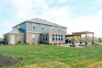 Inspiration for a small rustic backyard concrete paver patio remodel in Indianapolis with a fire pit and a pergola