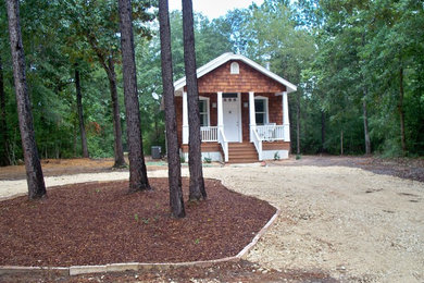 Mid-sized rustic brown one-story wood exterior home idea in Austin with a shingle roof