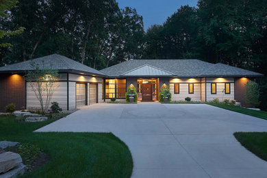 Design ideas for a midcentury brick house exterior in Grand Rapids.