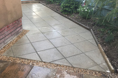 Photo of a medium sized modern courtyard patio in Sussex with concrete paving.