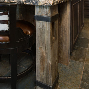 Large rustic u-shaped open plan kitchen in Other with a submerged sink, brown cabinets, granite worktops, multi-coloured splashback, glass tiled splashback, integrated appliances, slate flooring, an island, multi-coloured floors and multicoloured worktops.