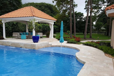 Inspiration for a large timeless backyard stone and rectangular lap pool fountain remodel in Other
