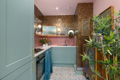 Photo of a small eclectic l-shaped separate kitchen in Edinburgh with a single-bowl sink, shaker cabinets, blue cabinets, laminate benchtops, pink splashback, ceramic splashback, stainless steel appliances, vinyl floors, no island, multi-coloured floor and grey benchtop.