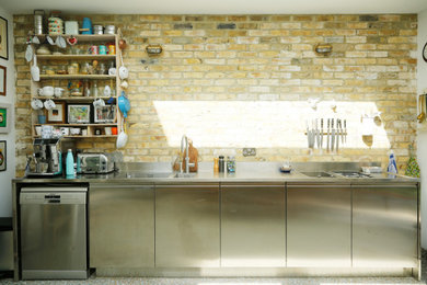 Inspiration for a medium sized modern single-wall kitchen/diner in London with a double-bowl sink, flat-panel cabinets, stainless steel cabinets, stainless steel worktops, grey splashback, stainless steel appliances, terrazzo flooring, no island, multi-coloured floors and grey worktops.